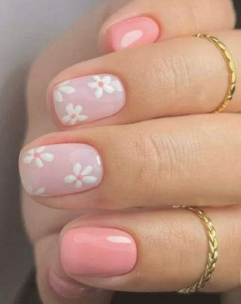 Soft pink and coral nails with white daisy flowers